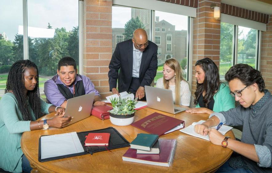 pioneer leadership students around table with professor